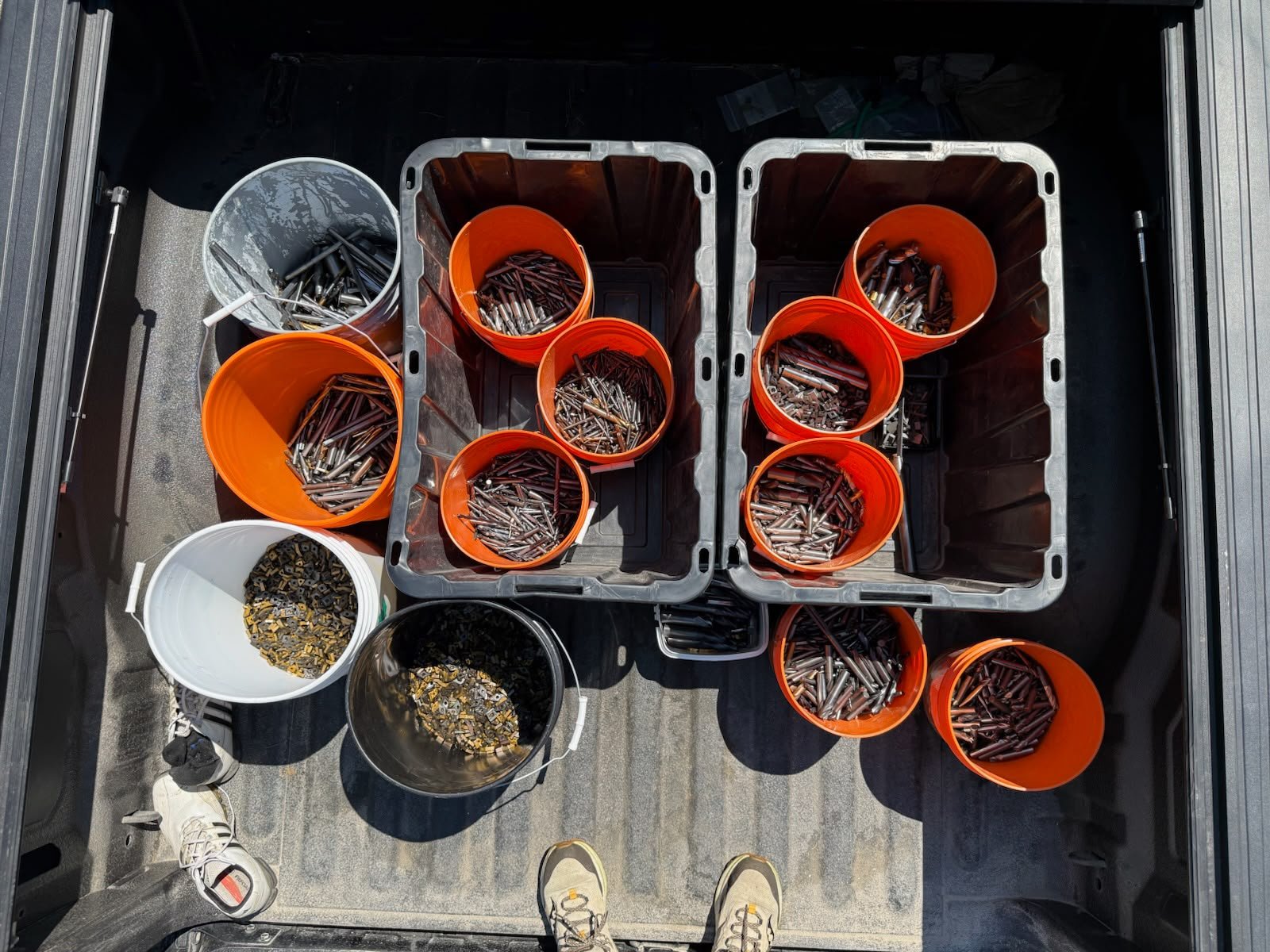 Multiple buckets of industrial carbide scrap prepared for pickup.